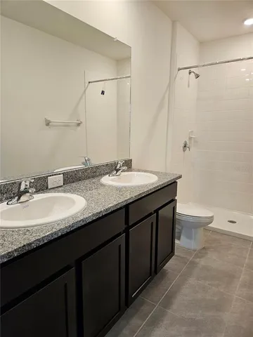 a bathroom with a shower and a toilet