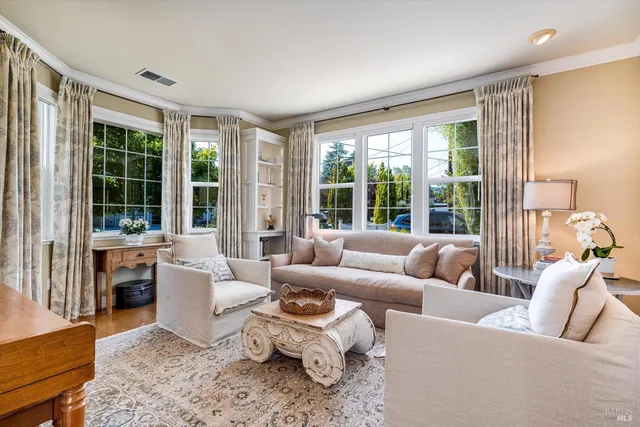 a view of a dining room with furniture large windows and wooden floor