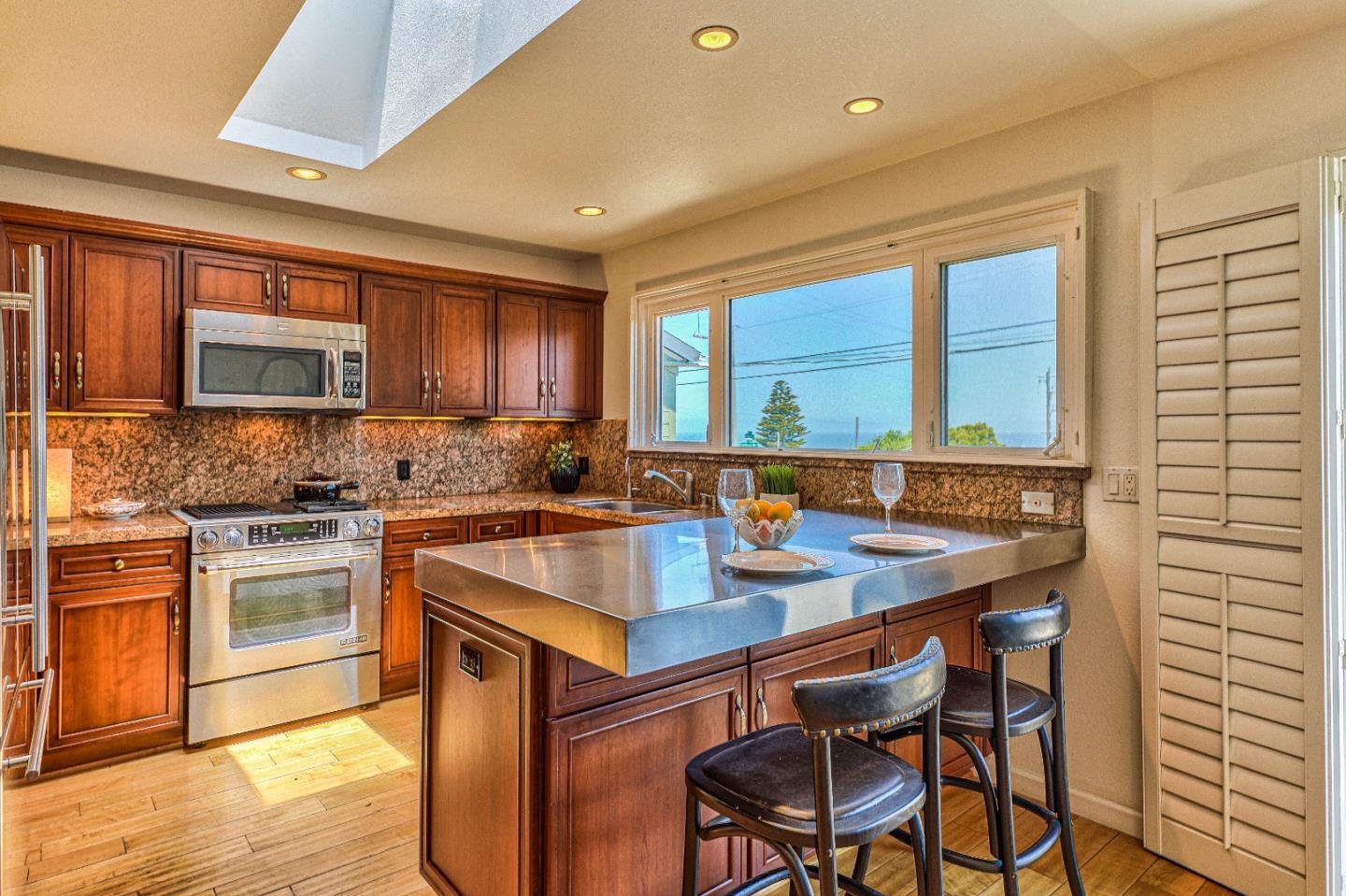 591 Belden Street Monterey, CA 93940 - Photo 11 of 27 a kitchen with a sink stove and cabinets