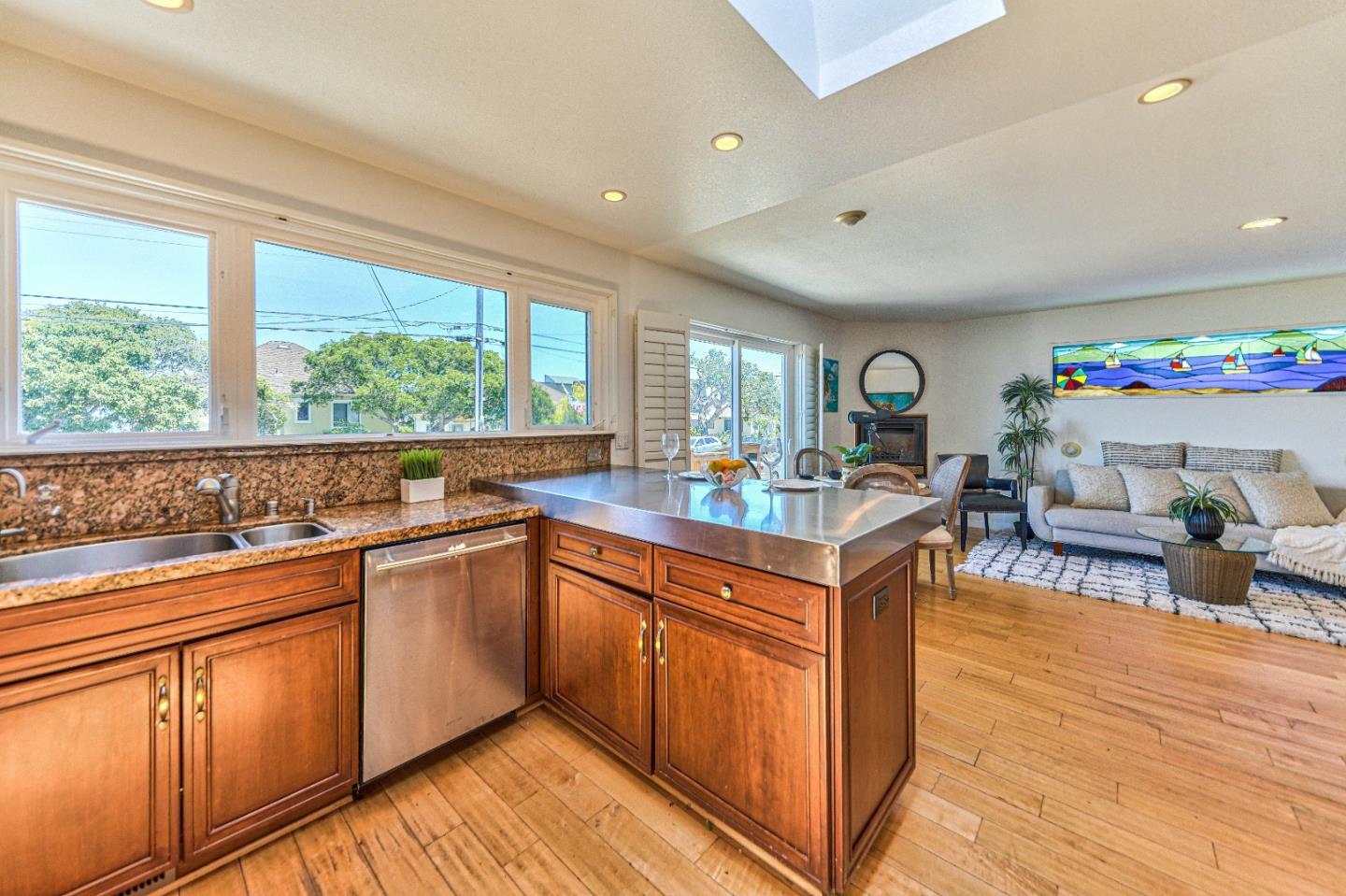 591 Belden Street Monterey, CA 93940 - Photo 12 of 27 a kitchen with stainless steel appliances granite countertop sink stove and wooden cabinets