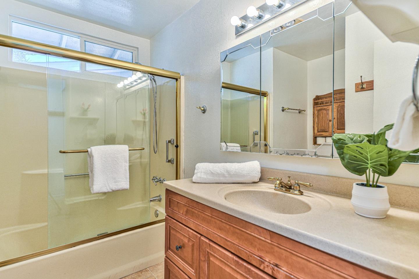 591 Belden Street Monterey, CA 93940 - Photo 18 of 27 a bathroom with a sink a mirror and a shower