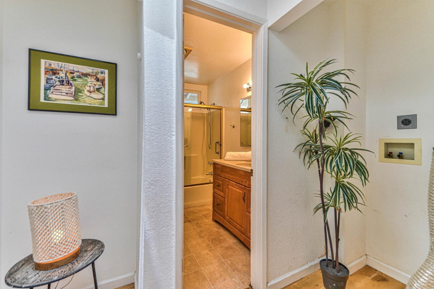 591 Belden Street Monterey, CA 93940 - Photo 19 of 27 a view of a hallway with furniture and a potted plant