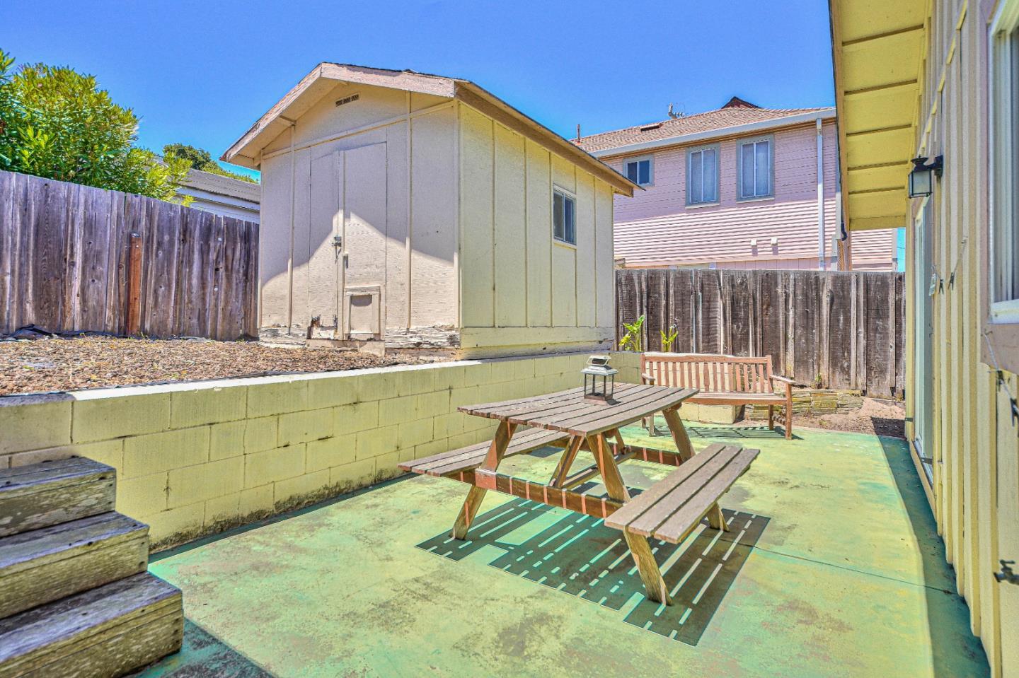 591 Belden Street Monterey, CA 93940 - Photo 22 of 27 a backyard of a house with table and chairs