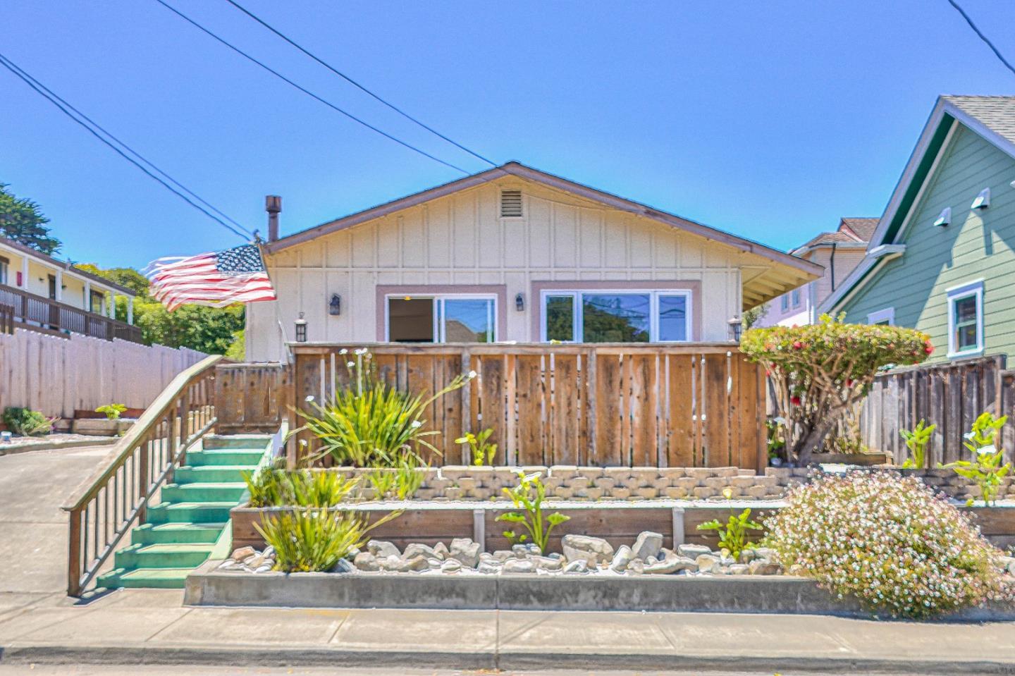 591 Belden Street Monterey, CA 93940 - Photo 3 of 27 a view of a house with a small yard and wooden fence