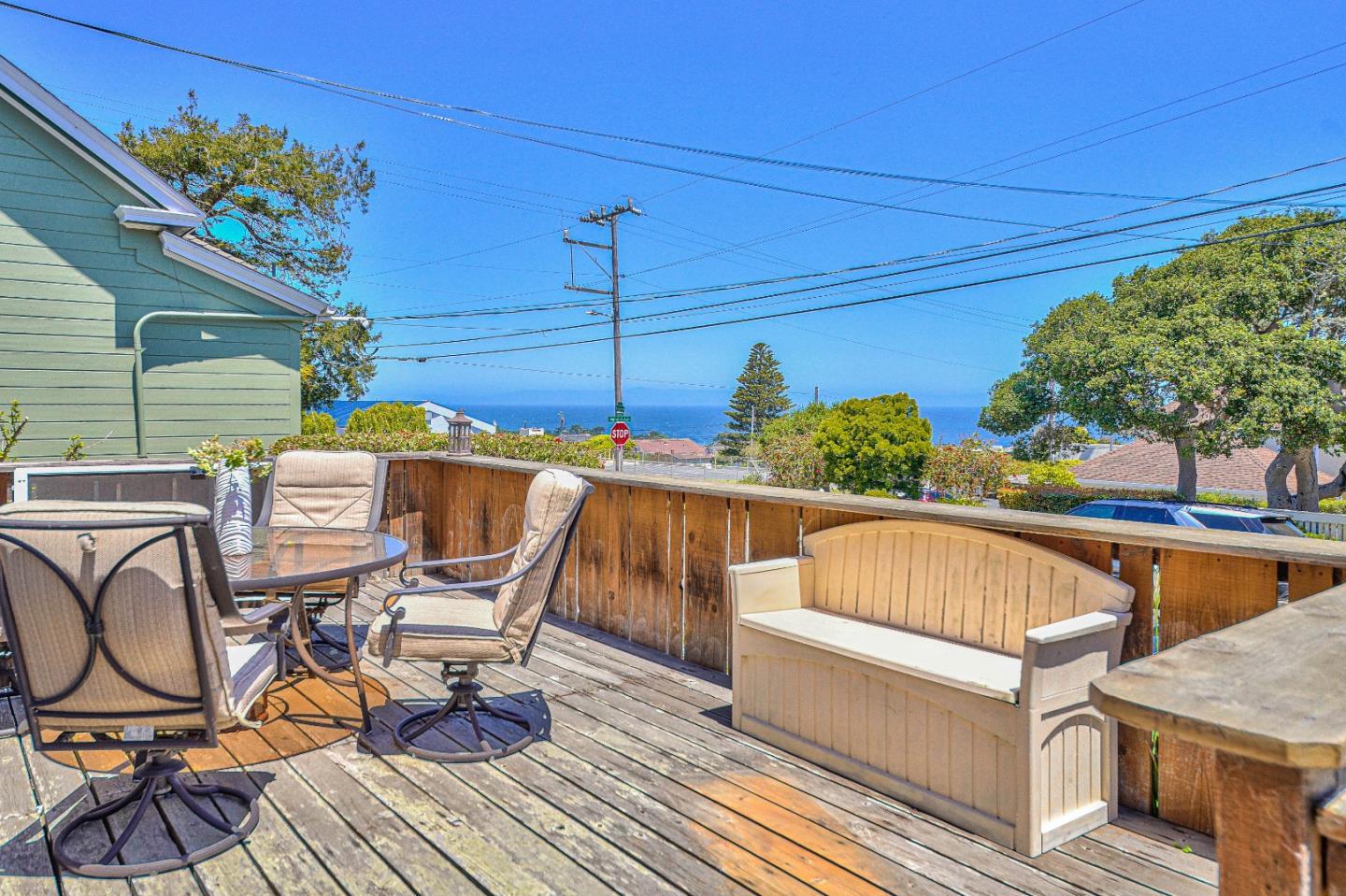 591 Belden Street Monterey, CA 93940 - Photo 10 of 27 a view of a patio with table and chairs with wooden floor and fence