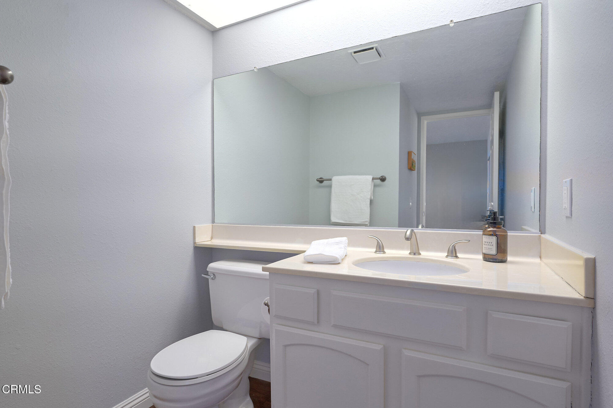 355 Jeremiah Drive, Unit D Simi Valley, CA 93065 - Photo 13 of 57 a bathroom with a toilet sink vanity and mirror