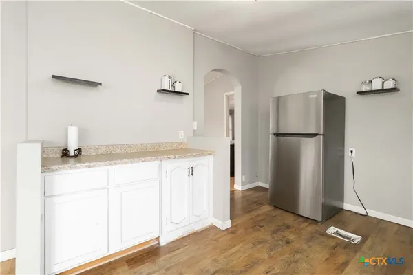 a kitchen with a refrigerator and a sink