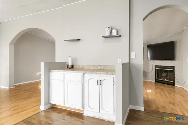 a hallway with a fireplace and a television