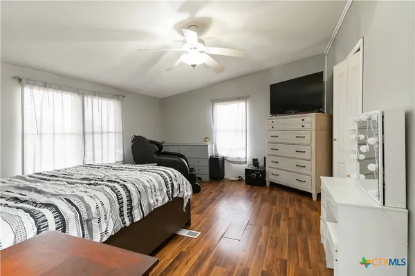 a bedroom with a bed and flat screen tv