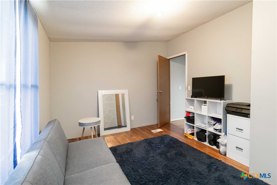 182 Pintail Loop San Marcos, TX 78666 - Photo 21 of 26 a living room with furniture and a flat screen tv