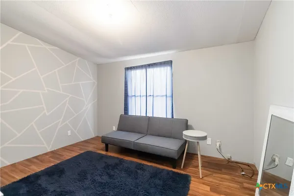 a living room with furniture and a rug