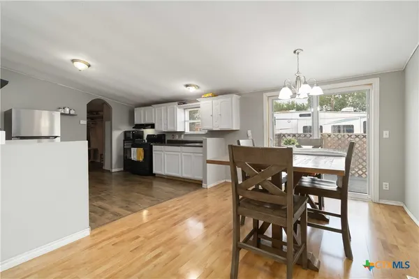 a view of a dining room with furniture and chandelier