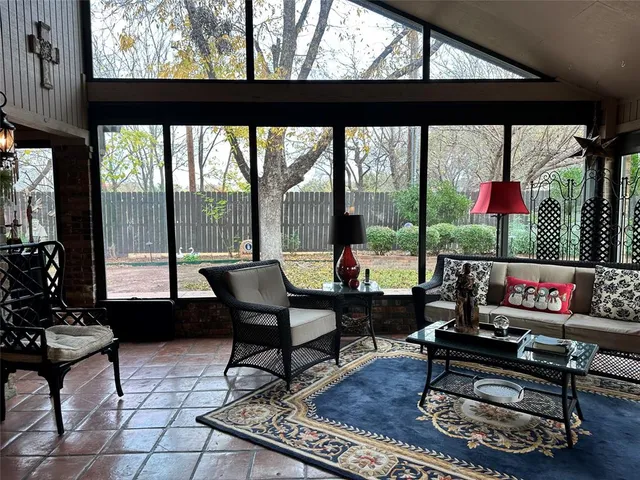 a living room with furniture and a floor to ceiling window