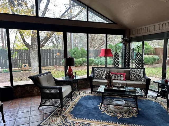 a living room with furniture and a floor to ceiling window