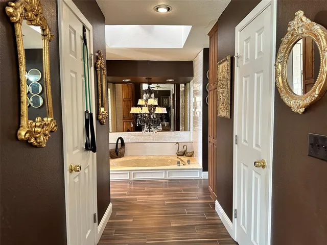 a view of a hallway with entryway wooden floor and front door