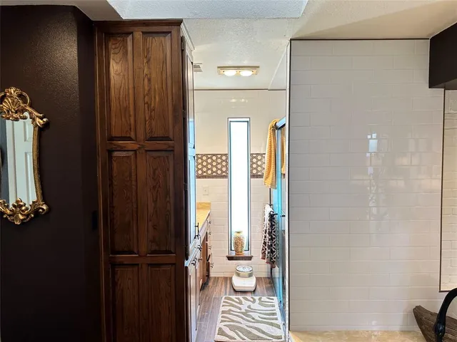a bathroom with a glass shower door