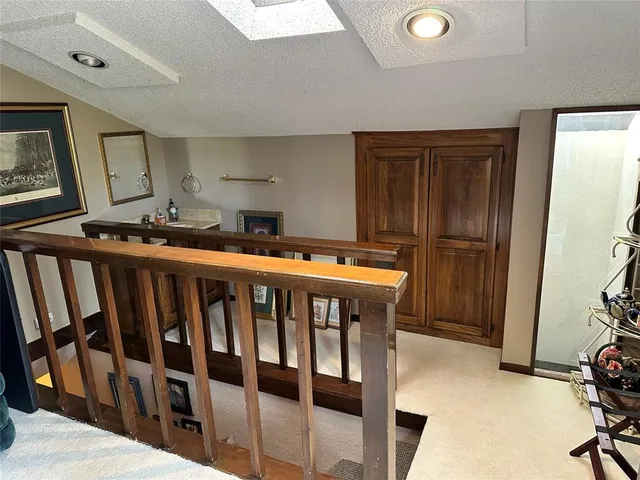 a view of a hallway with seating area