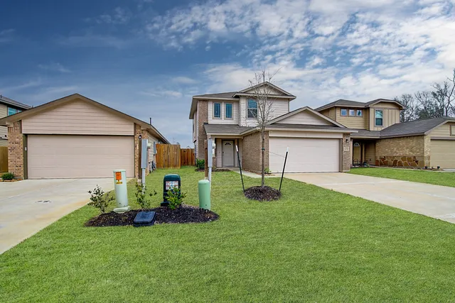a front view of a house with a yard and garage