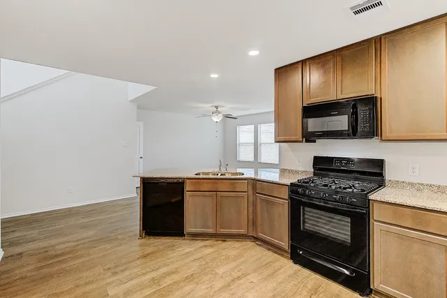 a kitchen with granite countertop a stove and a sink
