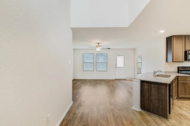 a view of a kitchen with wooden floor and sink