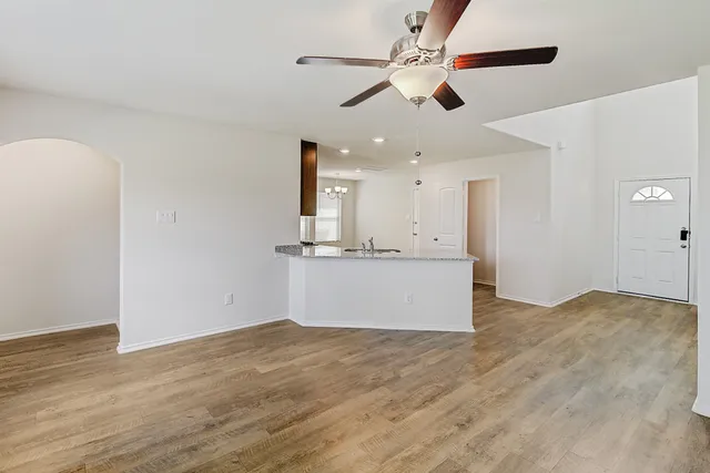 a view of kitchen with microwave and ceiling fan