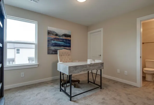 a workspace with furniture and a window