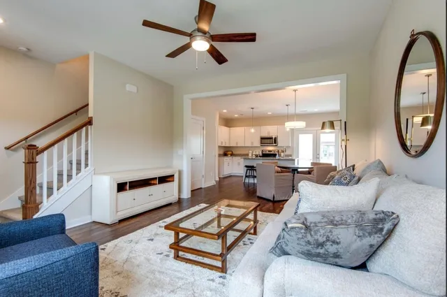 a living room with furniture a rug and a chandelier