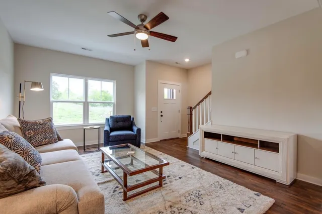 a living room with furniture and wooden floor