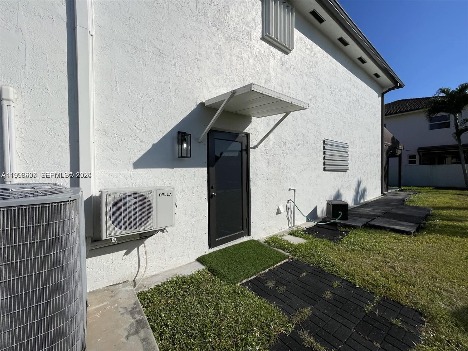 3403 Southwest 150th Court, Unit 1 Miami, FL 33185 - Photo 2 of 6 a front view of a house with garden