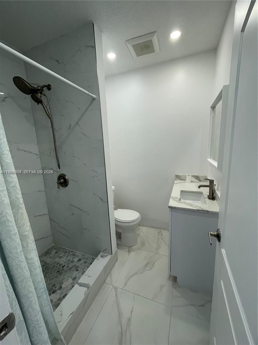 3403 Southwest 150th Court, Unit 1 Miami, FL 33185 - Photo 5 of 6 a bathroom with a sink a toilet and shower