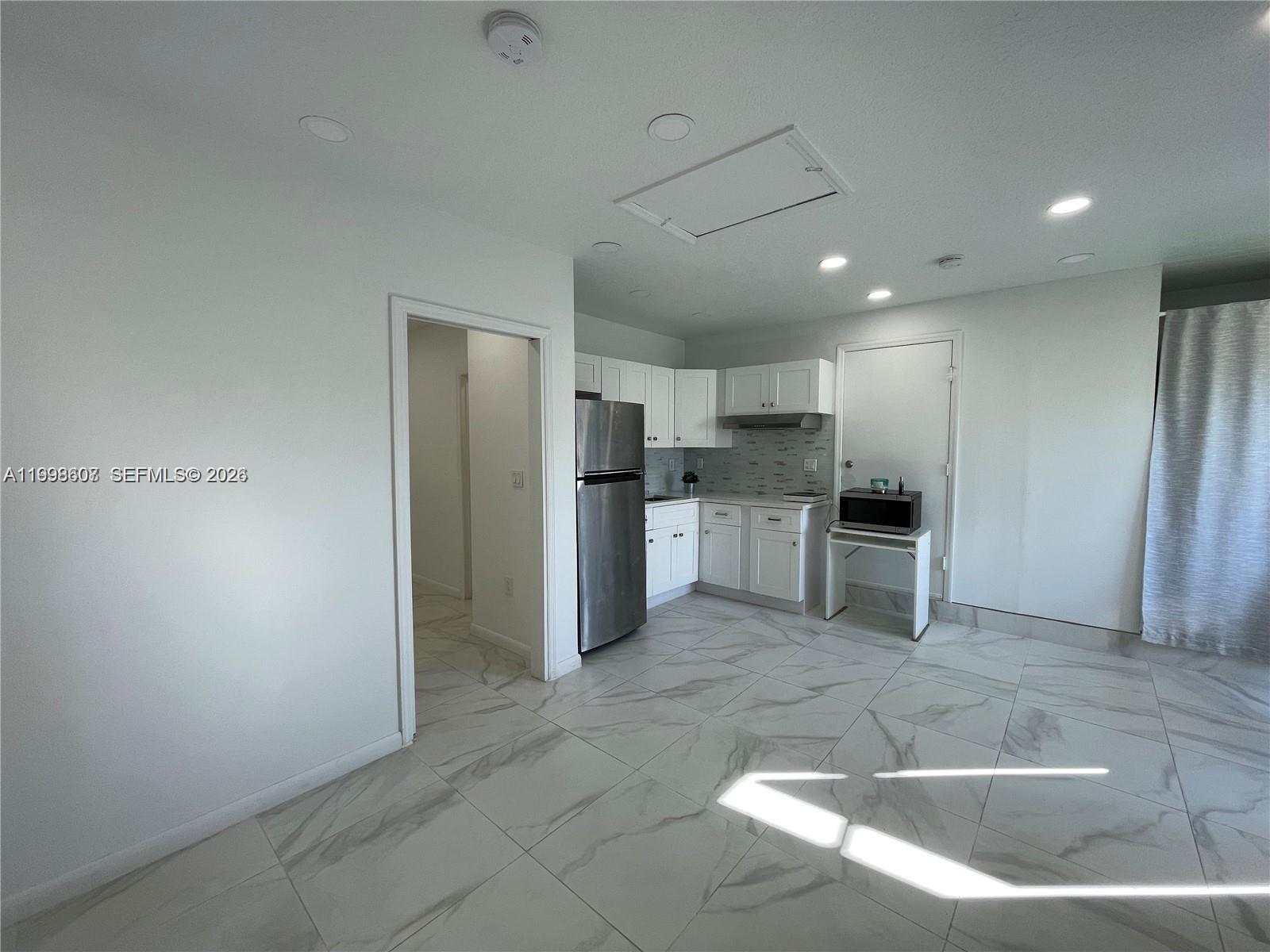 3403 Southwest 150th Court, Unit 1 Miami, FL 33185 - Photo 6 of 6 a kitchen with stainless steel appliances granite countertop a refrigerator and a sink