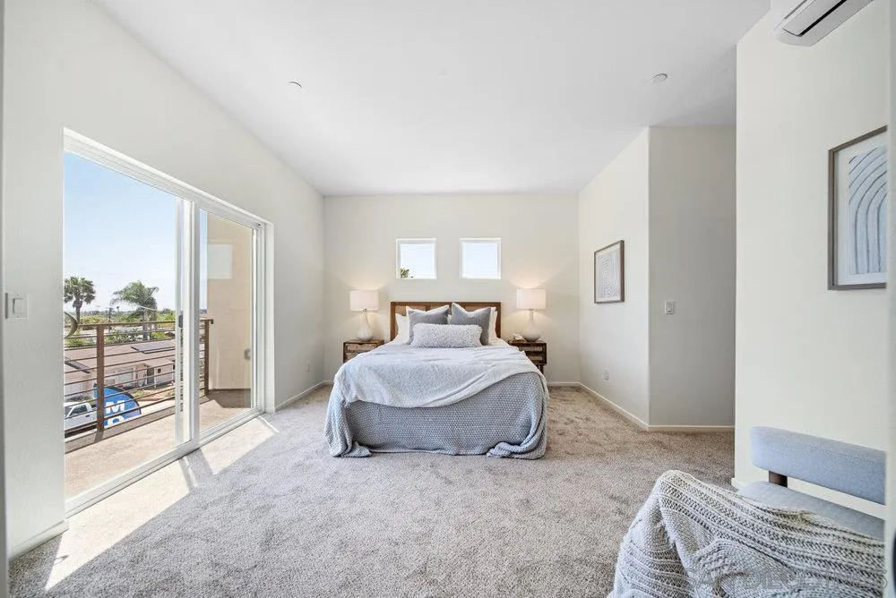 8188 Golden Avenue Lemon Grove, CA 91945 - Photo 19 of 47 a spacious bedroom with a bed and a large window