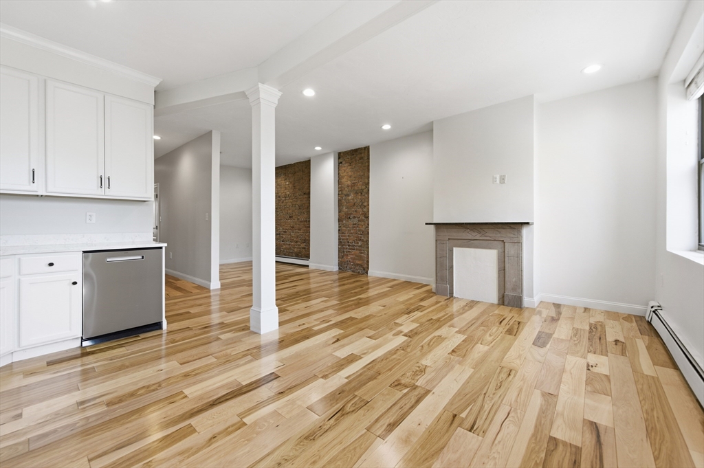 54 Beacon Street, Unit 2 Chelsea, MA 02150 - Photo 2 of 26 a view of empty room with wooden floor and fireplace