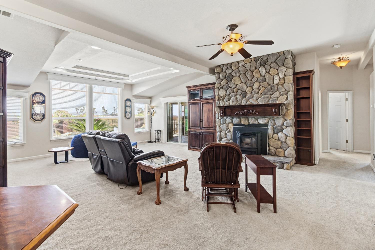 12390 Hobday Road Wilton, CA 95693 - Photo 8 of 92 a living room with furniture and a fireplace