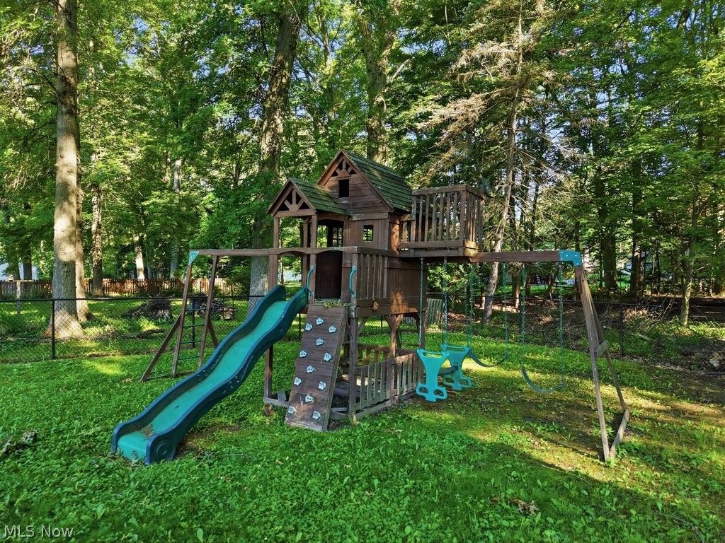 136 Pinehurst Road Munroe Falls, OH 44262 - Photo 41 of 48 Spacious backyard featuring a wooden play structure with a slide, swings, and climbing wall