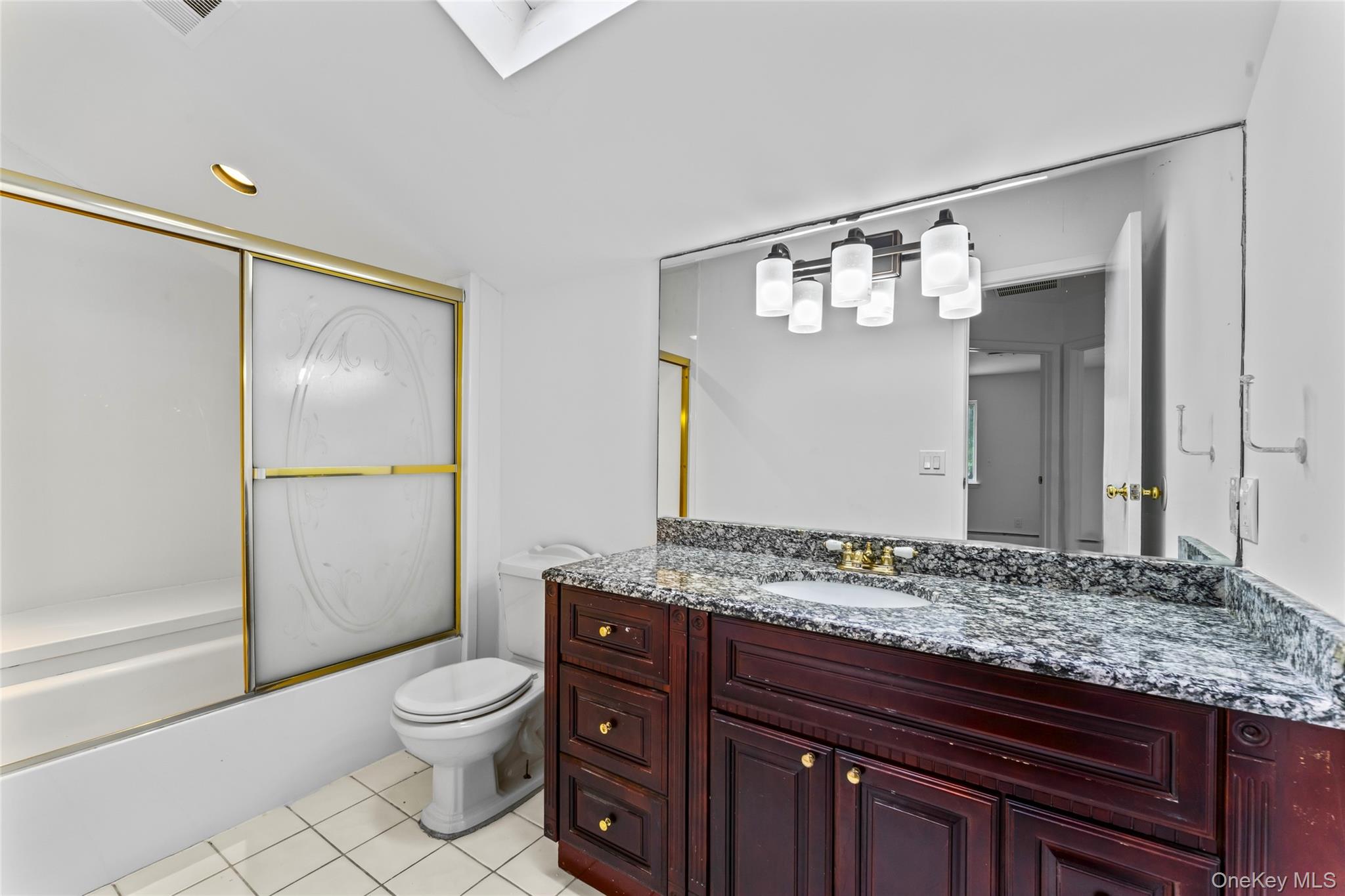 126 Bagatelle Road Melville, NY 11747 - Photo 30 of 50 a bathroom with a granite countertop sink toilet and mirror
