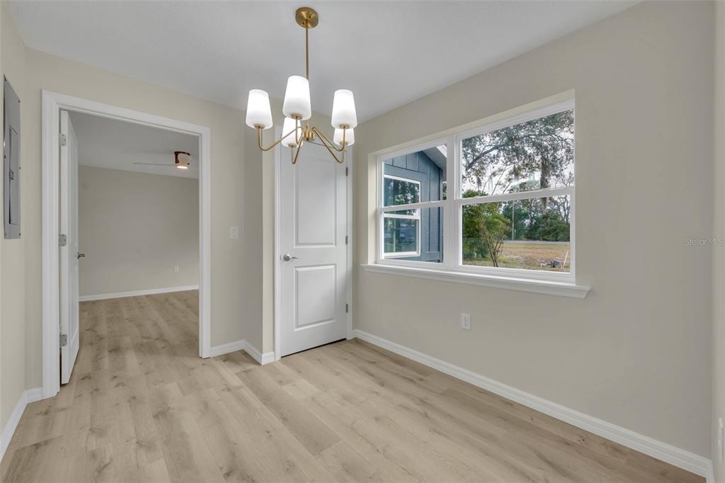 31201 Merry Road Tavares, FL 32778 - Photo 21 of 40 a view of a livingroom with a chandelier fan and windows