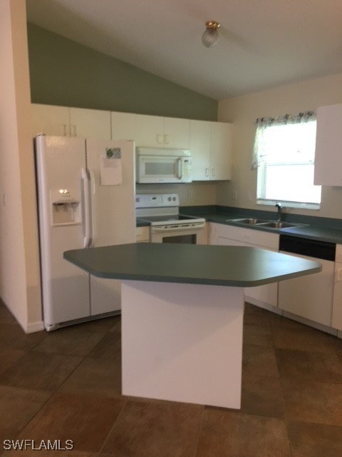 3527 Southwest 5th Street Cape Coral, FL 33991 - Photo 2 of 14 a kitchen with granite countertop a sink a stove and a refrigerator