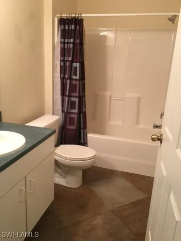 a bathroom with a toilet a sink and shower