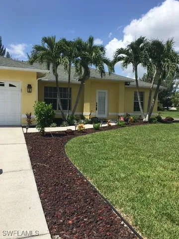 a front view of a house with garden