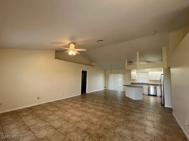 a view of a kitchen with a sink and chandelier
