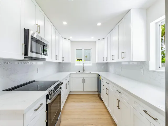 a kitchen with a sink stove and microwave