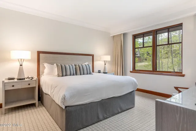 a bedroom with a large bed and a window