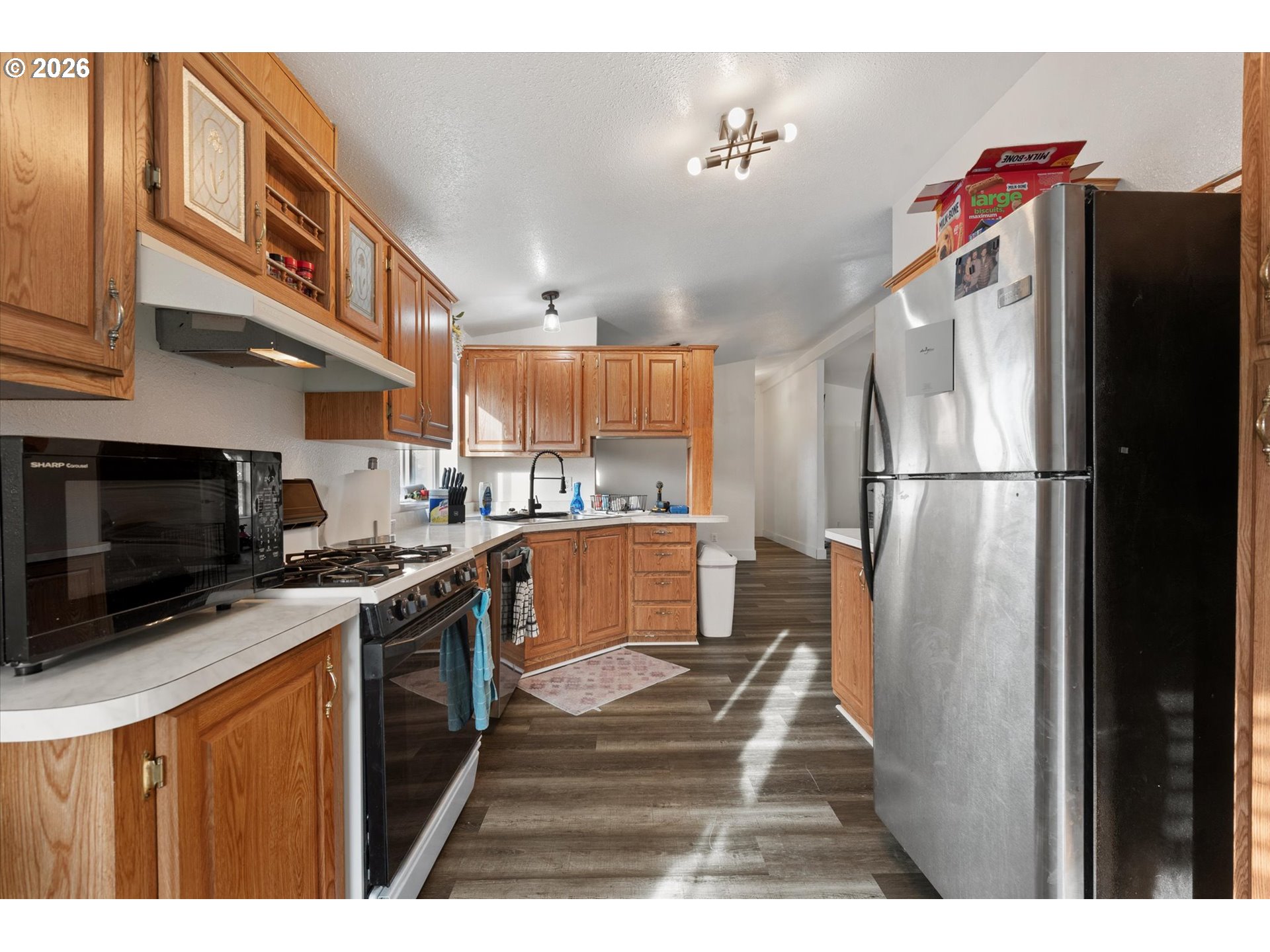 2106 Colorado Place Baker City, OR 97814 - Photo 27 of 40 a kitchen with stainless steel appliances granite countertop a refrigerator a stove top oven a sink and dishwasher
