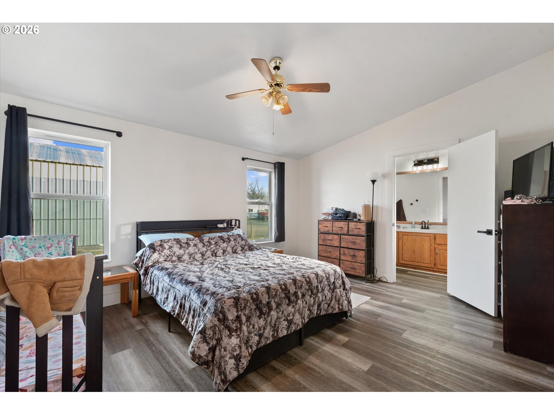 2106 Colorado Place Baker City, OR 97814 - Photo 31 of 40 a bedroom with a bed a dresser and wooden floor