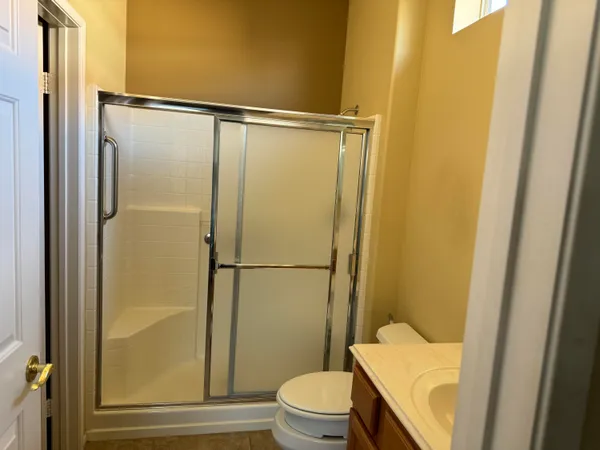 a bathroom with a shower toilet and sink