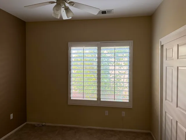 a view of a street with a bench under an umbrella