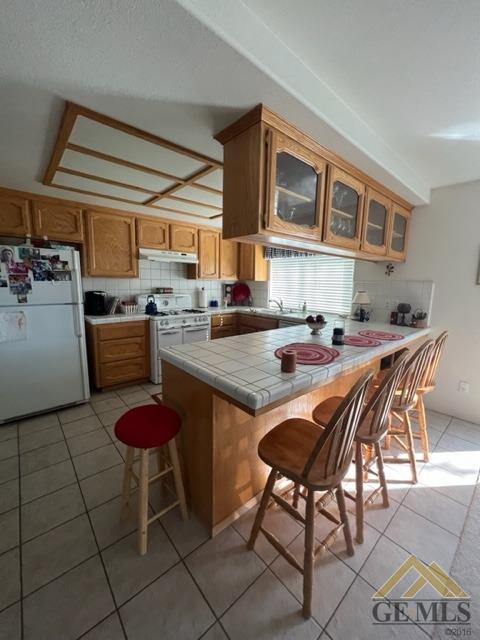 Undisclosed Address Tehachapi, CA 93561 - Photo 12 of 28 a table and chairs in a kitchen