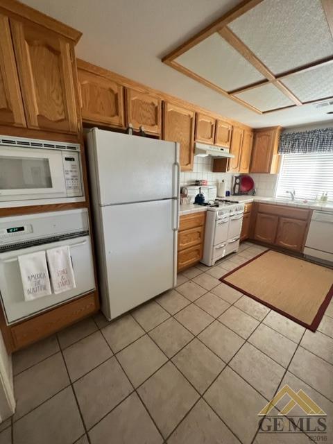 Undisclosed Address Tehachapi, CA 93561 - Photo 18 of 28 a kitchen with a refrigerator and a stove top oven