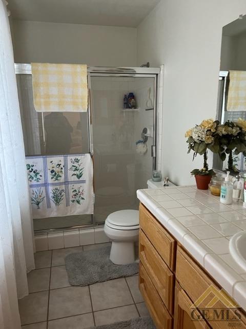 Undisclosed Address Tehachapi, CA 93561 - Photo 25 of 28 a bathroom with a granite countertop sink a toilet and shower